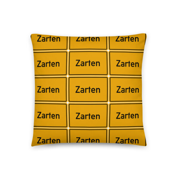 Ein gelbes Kissen mit dem Zarten Basic-Kissen-Logo.