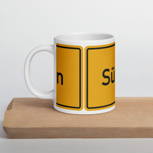 Eine gelb-schwarze Süßen - Weiße, glänzende Tasse mit der Aufschrift „stun“.